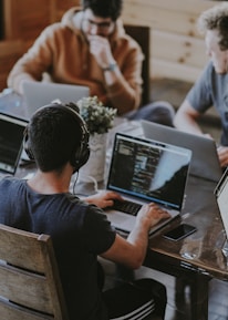 group of people using laptop computer