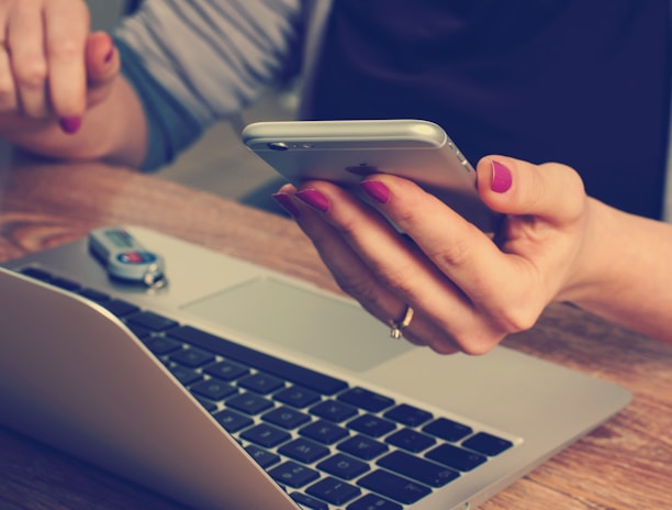 woman holding silver iPhone 6