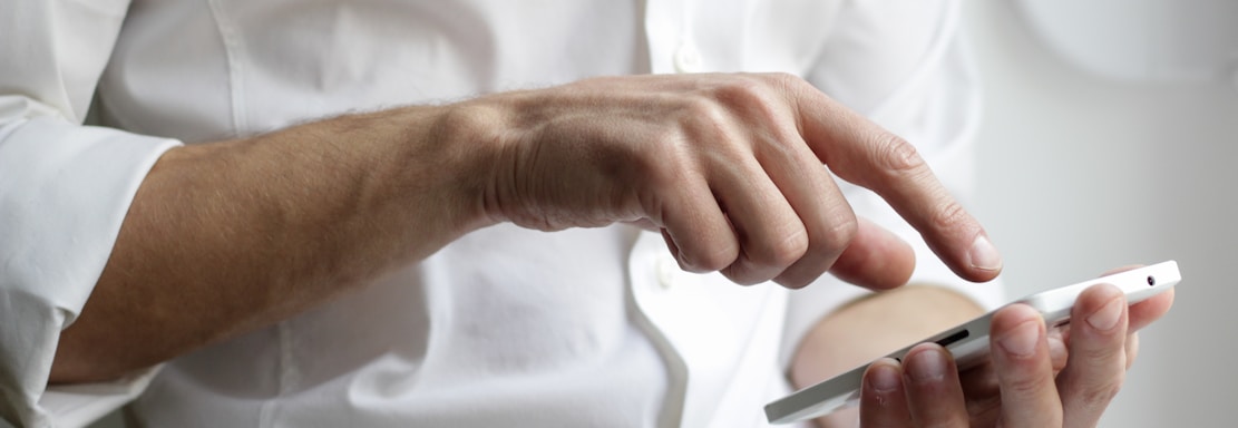 person holding white Android smartphone in white shirt